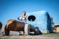 A Young girl riding a automobile made out of wood