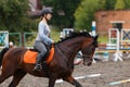 Young girl riding bay horse on equestrian sport training Royalty Free Stock Photo