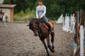 Young girl riding bay horse on equestrian sport training Royalty Free Stock Photo