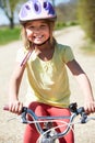 Young Girl Riding Bike Along Country Track