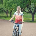 Young girl riding a bike in a park. Royalty Free Stock Photo