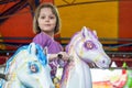 Young girl riding carousel horses Royalty Free Stock Photo