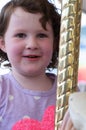 Young girl riding on fairground horse on carousel amusement ride at fairgrounds park outdoor Royalty Free Stock Photo