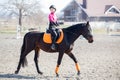 Young girl riding horse on equestrian training Royalty Free Stock Photo