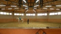 Young girl riding horse indoors. Royalty Free Stock Photo