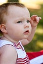 Young girl riding in red wagon having fun in the park for July Fourth Royalty Free Stock Photo