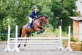 Young girl riding sorrel horse on show jumping Royalty Free Stock Photo