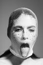 Young girl, robber bandit gangster wears mask of white fishnet