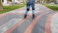 Young girl on the rollerblades on the alley