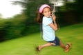 Young girl on rope swing