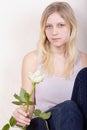 Young girl with rose sits calmly Royalty Free Stock Photo