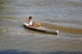 Young girl rowing on wooden canoe in the Brazilian Amazon