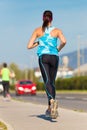 Young girl runner on the street.