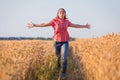 Young girl running on ripe wheat field Royalty Free Stock Photo