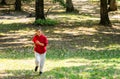 Young girl running in the woods