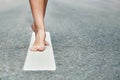 Young girl`s bare feet stand on the divivding road line Royalty Free Stock Photo