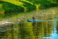 A young girl is sailing in a canoe on the Nitra river