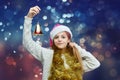 Young girl in a Santa hat holds a bell. photo shoot in the studio on a gray background Royalty Free Stock Photo