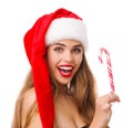 A young girl in a santa hat holds a lollipop in her hand. Royalty Free Stock Photo