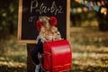 Young girl in school uniform writing on a board outdoor. Back to school