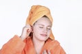 Young girl scratch ears using a cotton swab. Expressing enjoyment on face