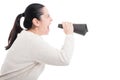 Young girl screaming in a paper loudspeaker