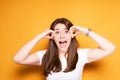 A young girl screams with pain in her teeth after installing braces, touching her head with her hands