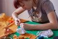 Young girl seamstress sews blank for mask.