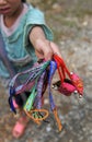 Young girl selling homemade colorful bracelets in Sapa, Vietnam