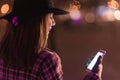 Young girl sending sms christmass wishes during winter alone in Royalty Free Stock Photo