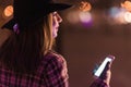 Young girl sending sms christmass wishes during winter alone in Royalty Free Stock Photo