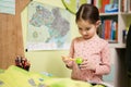 Young girl sharpening pencil in her room Royalty Free Stock Photo