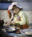 A young girl shelling scallops in vietnam