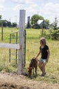 Young girl petting a miniature brown foal Royalty Free Stock Photo