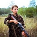 Young girl with a shotgun in an outdoor Royalty Free Stock Photo