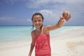 Young girl showing a crab shes collected on the beach