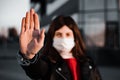 Young girl shows hand sign stop no to coronavirus epidemic pandemia originated at China. Covid-19 virus, nCov2019. Dramatic