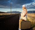 Young girl on side of road with suitcases Royalty Free Stock Photo