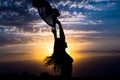 Young girl silhouette with shawl on background of beautiful cloudy blue sky with yellow golden sunset Royalty Free Stock Photo