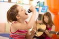 Young girl singing with microphone at home Royalty Free Stock Photo