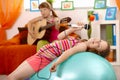 Young girl singing, posing on gym ball Royalty Free Stock Photo