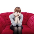 Young girl sit alone on red sofa