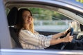 Young girl sit at driver seat in new car smiling hold hands on wheel happy to get driver license Royalty Free Stock Photo