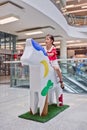 Young girl sit on horse sculpture at Livat Shopping Mall, Beijing, China