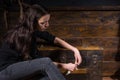 Young girl sits near a chest and trying to solve a conundrum to