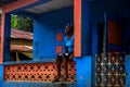 Young girl sits on the porch of her rural Haitian home. Royalty Free Stock Photo