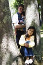 Young girl sitting against tree Royalty Free Stock Photo