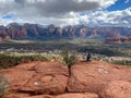 A young girl sitting at the Airport Mesa Sedona vortex overlooking Sedona, Arizona on a beautiful sunny winter day Royalty Free Stock Photo