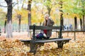 Young girl sitting on a bench in park Royalty Free Stock Photo