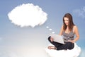 Young girl sitting on cloud and thinking of abstract speech bubble with copy space Royalty Free Stock Photo